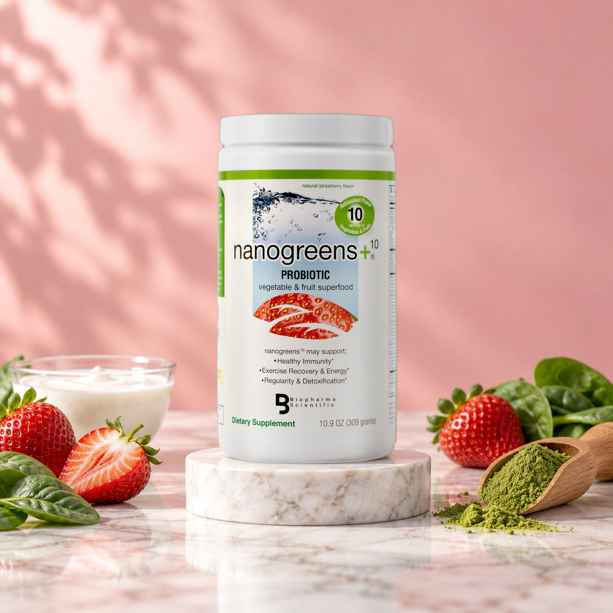 NanoGreens10+ Probiotic Strawberry tub in a bright studio still life with fresh ingredients
